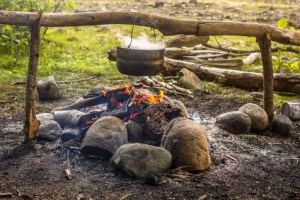 Cooking in a hike in the cauldron hanging over the fire